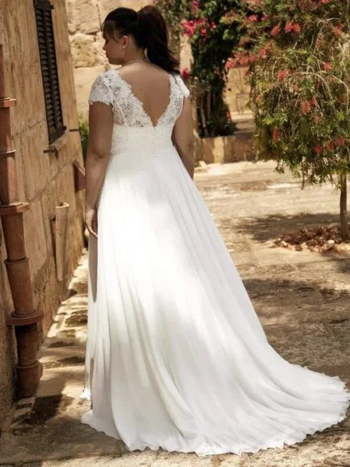 Robe de noce réalisée en grande taille dans une mousseline légère avec éléments décoratifs sur dentelle